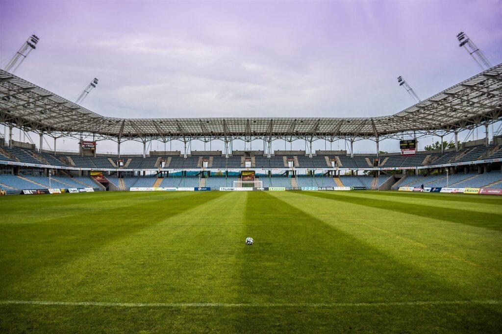 Un stade de football, vide avec seulement un ballon au centre.